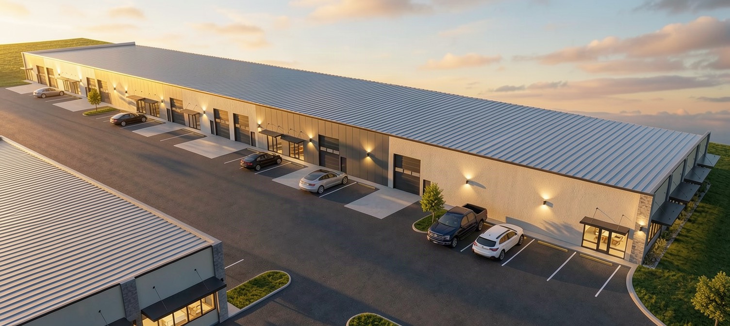 Aerial view along the roofline showing the drive-in doors and storefront entrances repeating down the building.